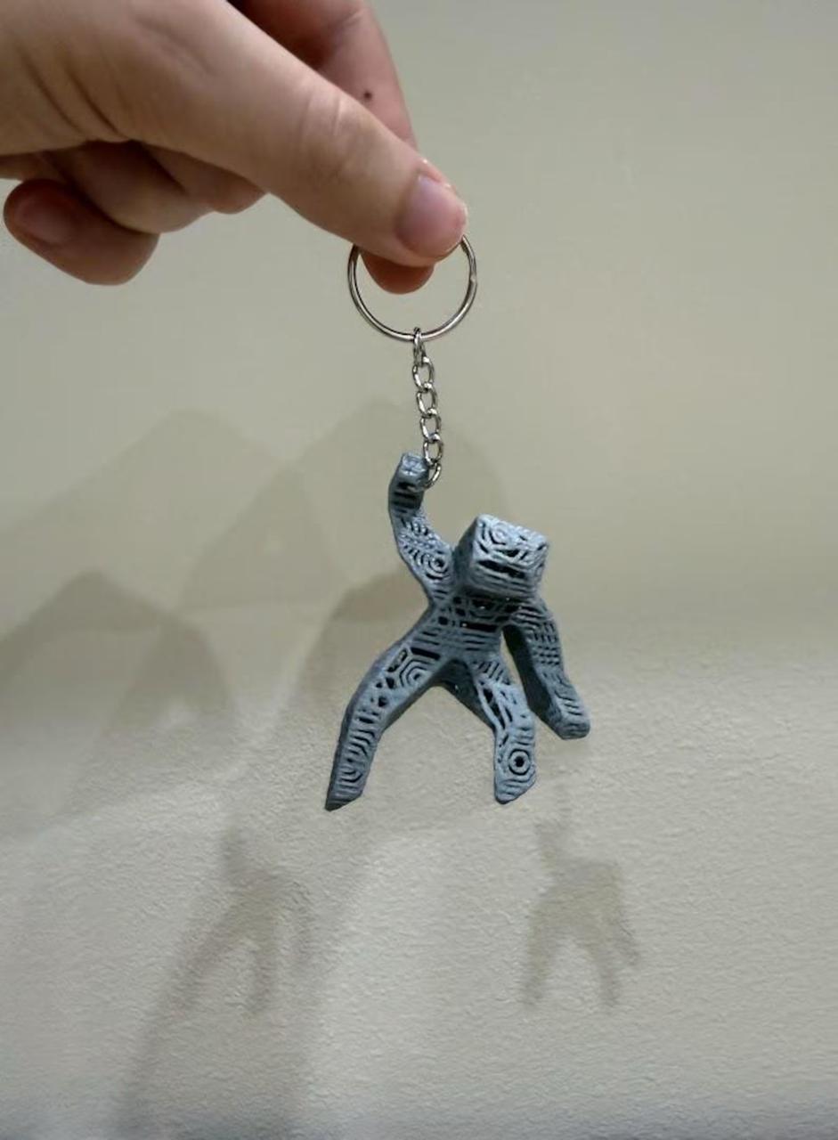 Keychain with a unique design held by a hand against a plain background