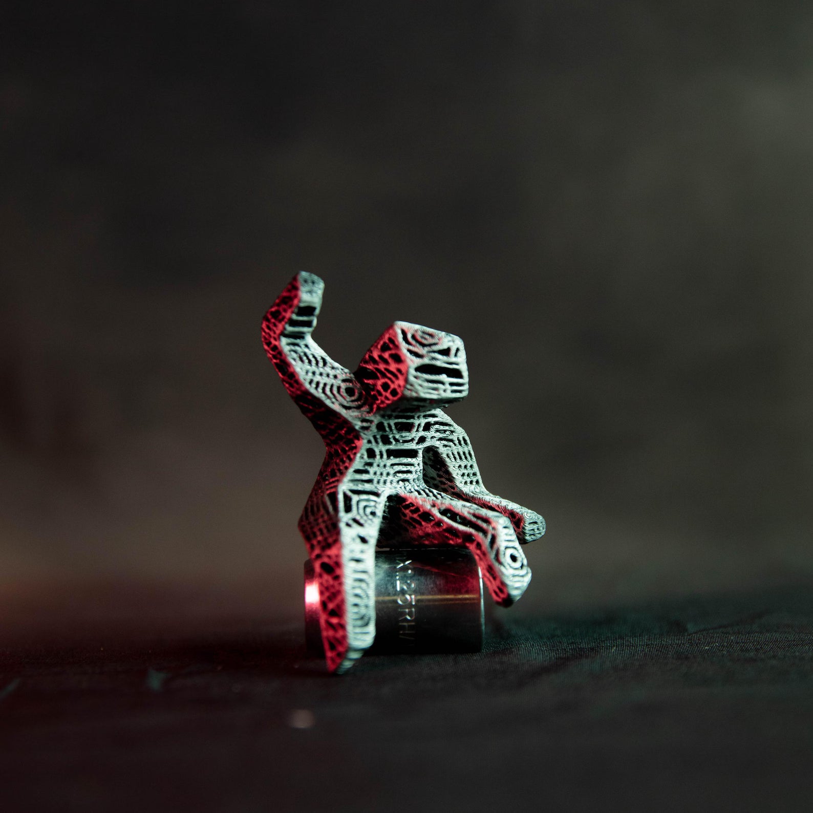 Metallic robot sculpture on a dark background